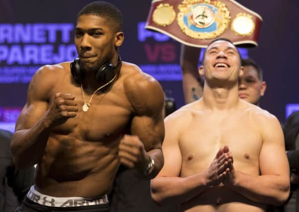 Anthony Joshua, left, and Joseph Parker at the weigh-in ahead of their world heavyweight unification clash in Cardiff: Picture: Getty