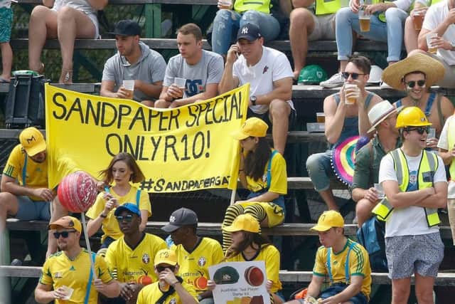 South Africa fans dressed as carpenters taunt the Australian team with a banner about the ball-tampering scandal. Picture: Gianluigi Guercia/AFP/Getty Images