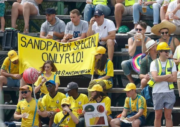 South Africa fans dressed as carpenters taunt the Australian team with a banner about the ball-tampering scandal. Picture: Gianluigi Guercia/AFP/Getty Images