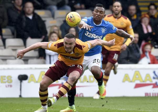 Motherwell'ss Tom Aldred (left) and Rangers' Alfredo Morelos battle for the ball. Picture: Ian Rutherford/PA Wire