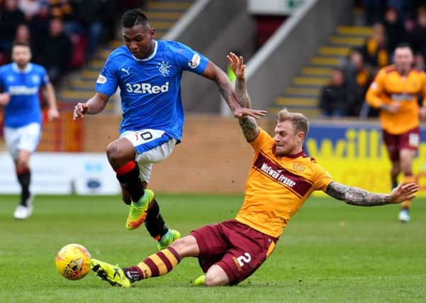 Rangers' Alfredo Morelos (left) skips away from Motherwell's Richard Tait. Picture: SNS/Craig Foy