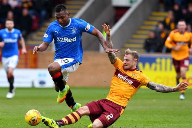 Rangers' Alfredo Morelos (left) skips away from Motherwell's Richard Tait. Picture: SNS/Craig Foy
