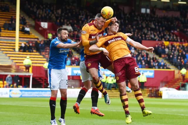Rangers' Russell Martin, jumps with Motherwell's Ryan Bowman and Carl McHugh. Picture: SNS/Craig Foy