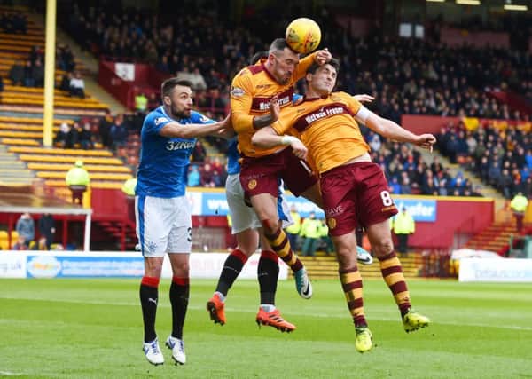 Rangers' Russell Martin, jumps with Motherwell's Ryan Bowman and Carl McHugh. Picture: SNS/Craig Foy