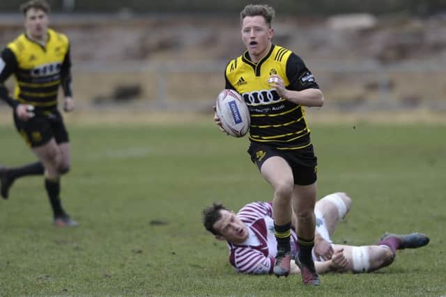 Murdo McAndrew of Melrose breaks clear after evading an attempted tackle by Watsonians' Mike Fedo. Picture: Neil Hanna.