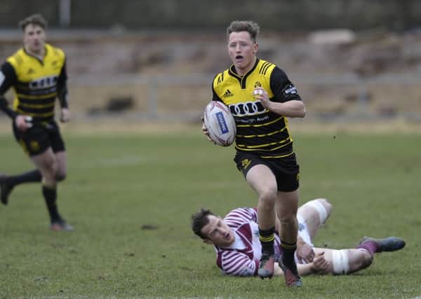 Murdo McAndrew of Melrose breaks clear after evading an attempted tackle by Watsonians' Mike Fedo. Picture: Neil Hanna.