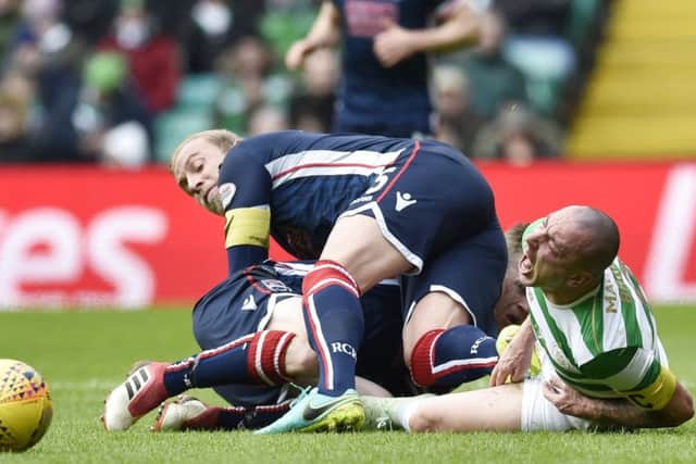 Ross County captain Andrew Davies fouls Celtic's Scott Brown which leads to him being sent off. Picture: SNS/Rob Casey