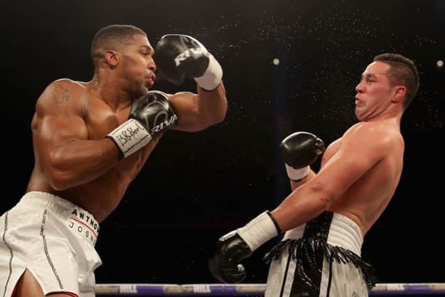 Anthony Joshua throws a punch at Joseph Parker during Saturday night's unification fight. Picture: Getty