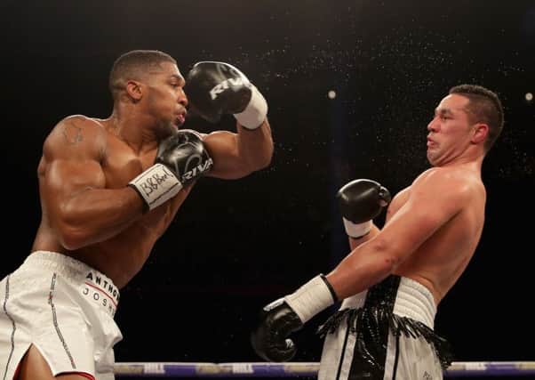 Anthony Joshua throws a punch at Joseph Parker during Saturday night's unification fight. Picture: Getty