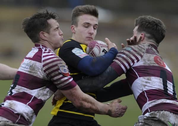 Mike Fedo and  Rory Hutton of Watsonians combine to halt Ross McCanns progress. Picture: Neil Hanna