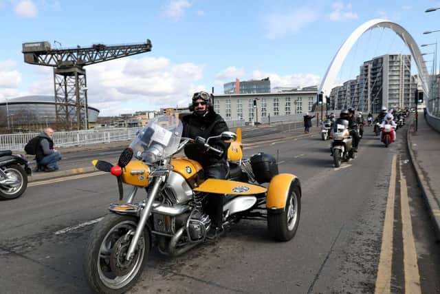 Biker Alf Grant travels across the  'Squinty' Bridge in Glasgow. Pic: PA Wire/Andrew Milligan