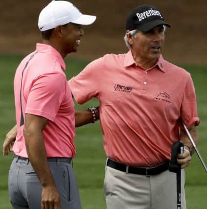 Tiger Woods shares a laugh with Fred Couples on the practice range at Augusta National. Picture: AP