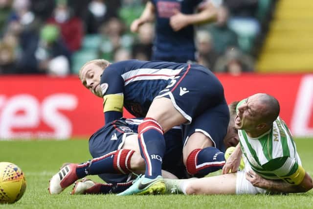Andrew Davies was sent off for a challenge on Scott Brown during Celtic's win over Ross County. Picture: SNS