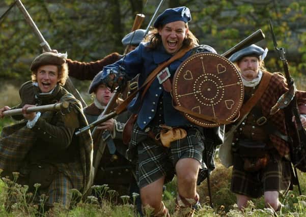 Jacobite re-enacters charge ahead of their battle in Prestonpans. Picture: TSPL