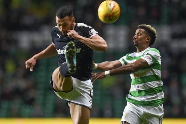 Dundee's impressive Steven Caulker challenges Celtic's Scott Sinclair. Picture: Craig Williamson/SNS