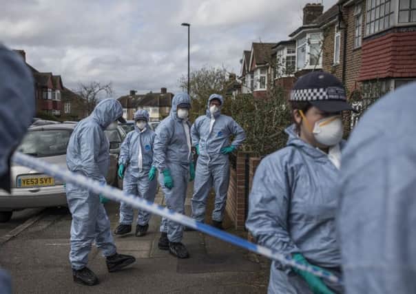 A forensic team search the street where the man died after the robbery. Picture: Dan Kitwood/Getty Images