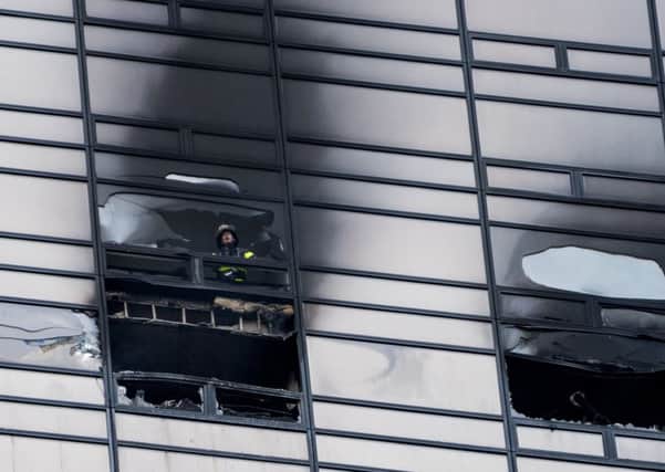 A firefighter at the fire scene in Trump Tower on New Yorks Fifth Avenue. Some 200 members of the emergency services rushed to the inferno. Picture: AP Photo/Craig Ruttle