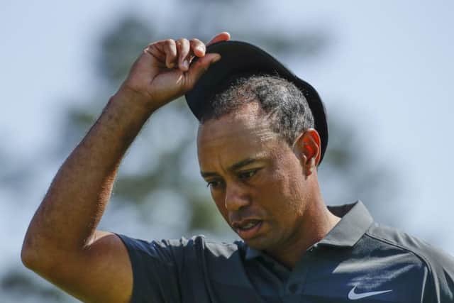 Tiger Woods looks dejected as he walks off the 18th green. He expected better than a first-round 73. Picture: AP