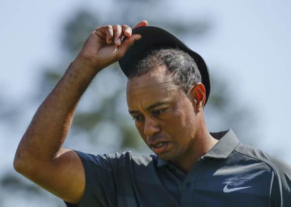 Tiger Woods looks dejected as he walks off the 18th green. He expected better than a first-round 73. Picture: AP