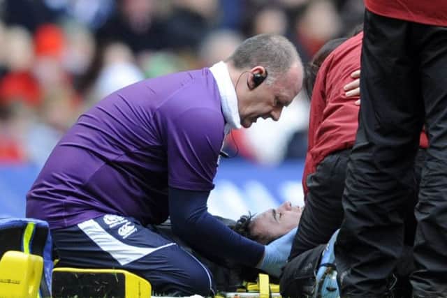 Scottish team doctor Dr James Robson attends to Thom Evans. Pic Ian Rutherford
