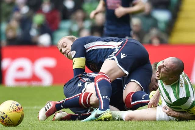 Ross County captain Andrew Davies fouls Celtic's Scott Brown. Picture: Rob Casey/SNS