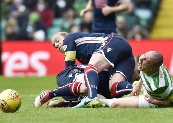 Ross County captain Andrew Davies fouls Celtic's Scott Brown. Picture: Rob Casey/SNS