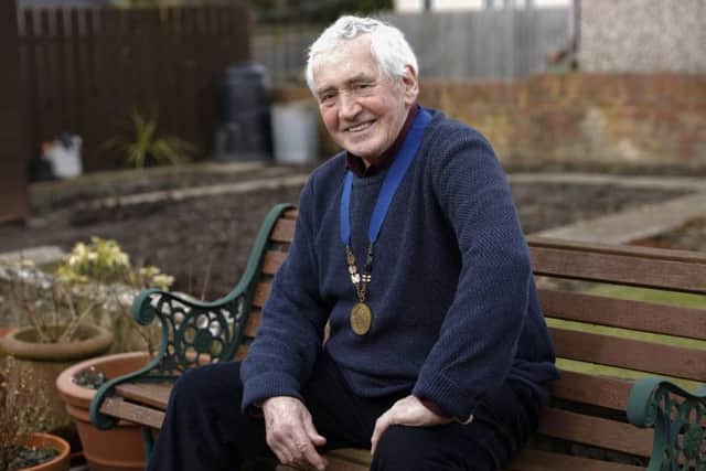 Jim Alder at his home in Ellington, Northumberland, with his 1966 Commonwealth Games marathon gold medal round his neck.Picture: John Millard.