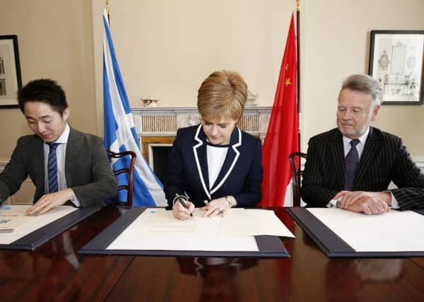 In Bute House Sturgeon signs up to the trade deal which was to cause her so much embarrassment. Picture: China Daily