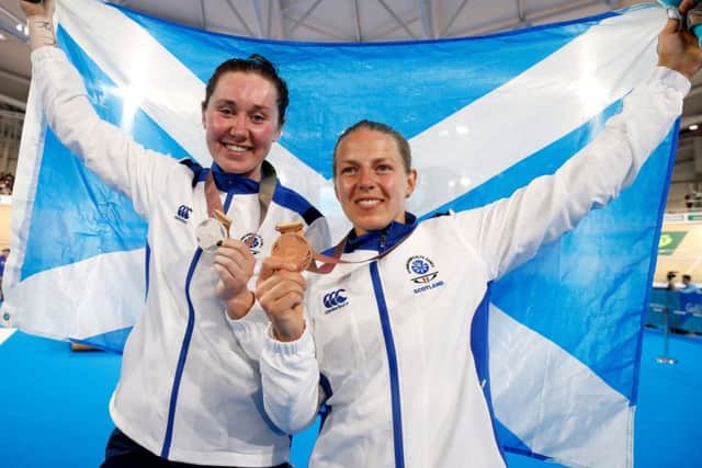 Scotland's Neah Evans, right, celebrates her bronze medal in the Commonwealth Games 25km points race with compatriot Katie Archibald who won silver. Picture: Martin Rickett/PA Wire