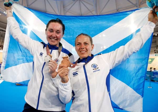 Scotland's Neah Evans, right, celebrates her bronze medal in the Commonwealth Games 25km points race with compatriot Katie Archibald who won silver. Picture: Martin Rickett/PA Wire