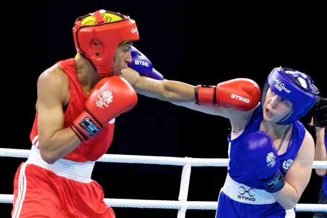 Vikki Glover of Scotland, right, lands a blow in her win over Valerian Spicer of Dominica. PICTURE: AP
