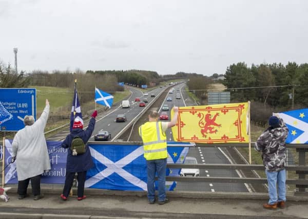 M8 independence flag protest, Bathgate. Scottish independence supporters campaign group fly flags and banners from bridges and footpaths. Picture; Ian Rutherford