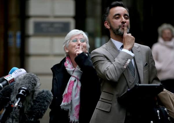 Clara Ponsati gestures to the media as she stands alongside her lawyer Aamer Anwar outside Edinburgh Sheriff Court after being released on bail.