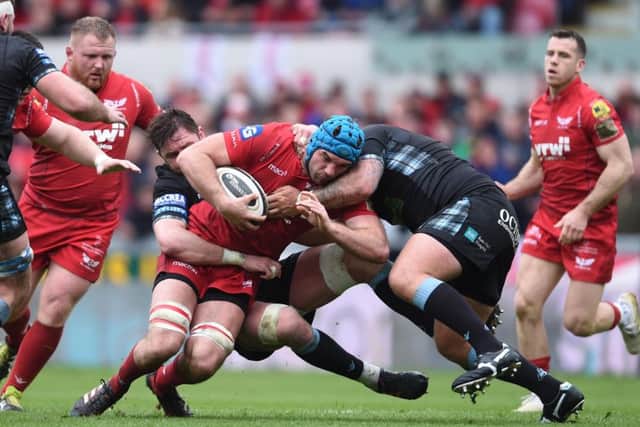 Tadhg Beirne of Scarlets is tackled by Ryan Wilson and Jamie Bhatti of Glasgow. Picture: Ben Evans/Huw Evans/REX/Shutterstock