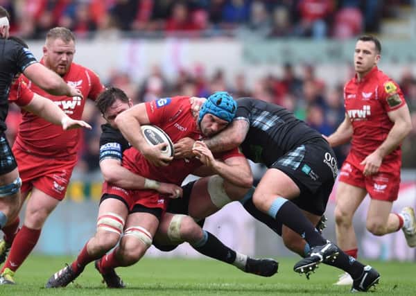 Tadhg Beirne of Scarlets is tackled by Ryan Wilson and Jamie Bhatti of Glasgow. Picture: Ben Evans/Huw Evans/REX/Shutterstock
