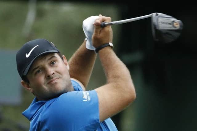 Leader Patrick Reed in an unsual finishing position as he tries to shape his drive at the 18th hole at Augusta National. Picture: Getty Images
