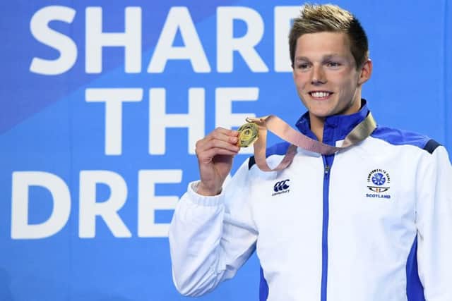 Duncan Scott shows off his gold for winning the Men's 100m Freestyle Final. Picture: Quinn Rooney/Getty Images
