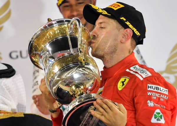 Sebastian Vettel kisses the trophy after continuing his impressive start to the season. Picture: AFP/Getty