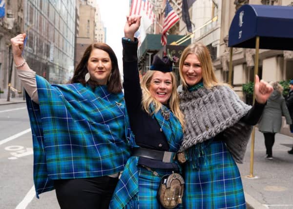 Louise Mitchell (centre) wearing the fair trade tartan with friends in New York at the Tartan Day Parade. Picture: Martin McAdam
