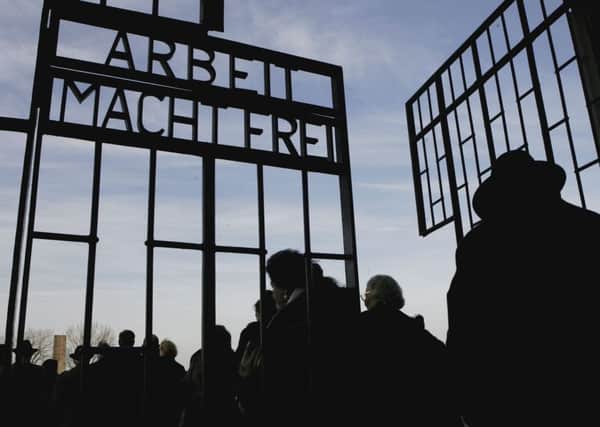 Survivors of the Holocaust enter a former concentration camp to mark the Auschwitz Decree of 1943, in which Heinrich Himmler ordered the deportation of Germanys remaining Roma to Auschwitz (Picture: Getty)