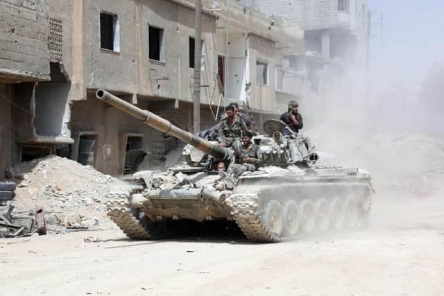Syrian Army soldiers on the eastern outskirts of Douma. Picture: AFP/Getty