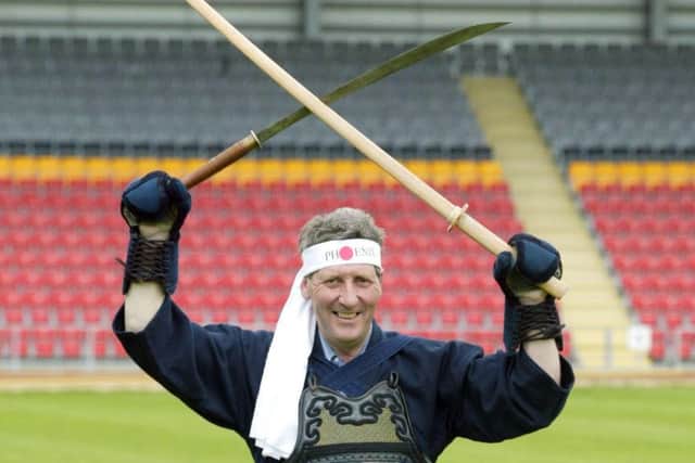 John Lambie gets dressed up to announce Partick Thistle's new club sponsor in 2002.
Picture: Roddy Scott/SNS
