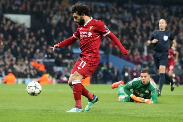 With Manchester City goalkeeper Ederson stranded, Mo Salah delightfully chips the ball into the net to put Liverpool back in control. Picture: PA.