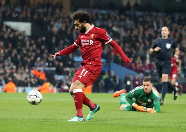 With Manchester City goalkeeper Ederson stranded, Mo Salah delightfully chips the ball into the net to put Liverpool back in control. Picture: PA.