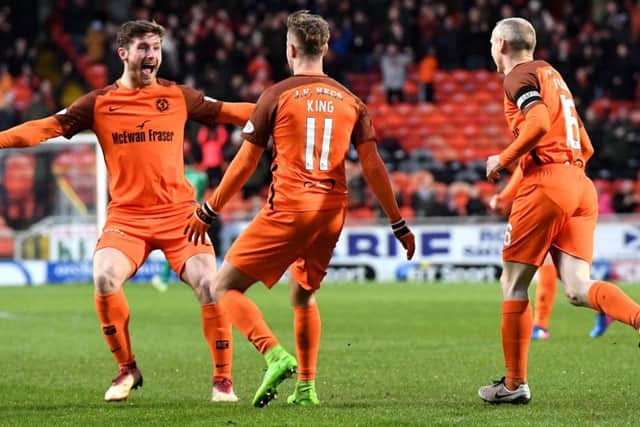 Dundee United matchwinner Billy King celebrates his early goal against St Mirren with team-mate Anthony Ralston. Picture: SNS.