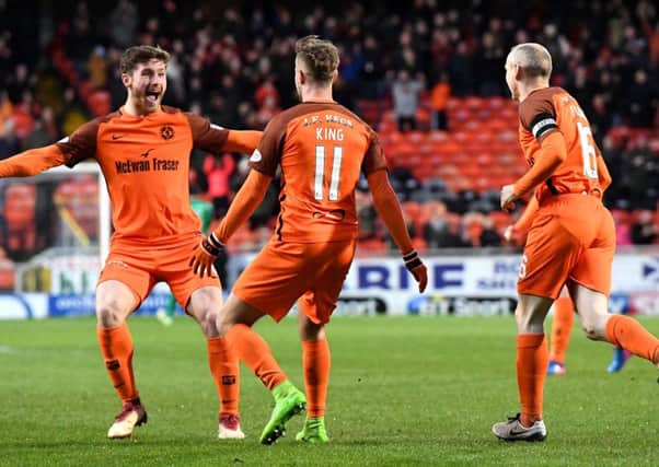 Dundee United matchwinner Billy King celebrates his early goal against St Mirren with team-mate Anthony Ralston. Picture: SNS.