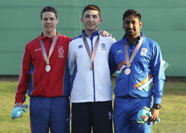 David McMath of Scotland, centre, with his gold meda in the men's double trap, flanked by silver medallist Tim Kneale of the Isle of Man and Ankur Mittal PICTURE: AP