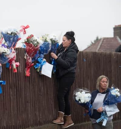 Friends and family of James Vincent establish the shrine. Picture: PA Wire