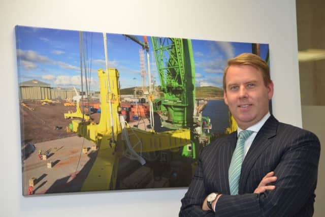 Atlantis chief Tim Cornelius in front of picture of turbine construction. Picture: Jon Savage