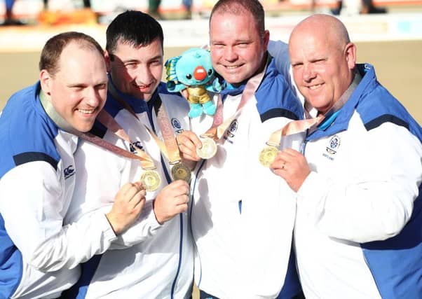 Alex Marshall, far right, celebrates gold with, from left, Ronald Duncan, Derek Oliver Paul Foster. PICTURE: Getty Images)